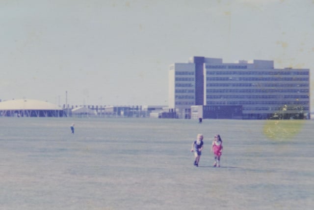Kids walk across Sighthill Park in the 1970s, with Stevenson College pictured in the background.