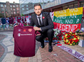 Hearts goalkeeper Craig Gordon with the tributes to Marius Zaliukas outside Tynecastle.