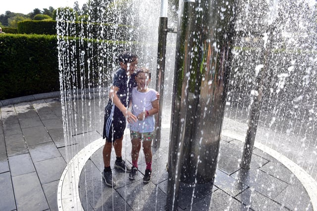 Molly Shorney, seven, and brother Elliot Shorney, 10, cooling off in the water fountains at The Alnwick Garden during the summer holidays.