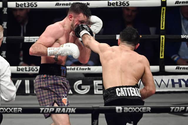 Josh Taylor is caught by Jack Catterall during the WBA, WBC, WBO & IBF world super-lightweight title fight at the OVO Hydro