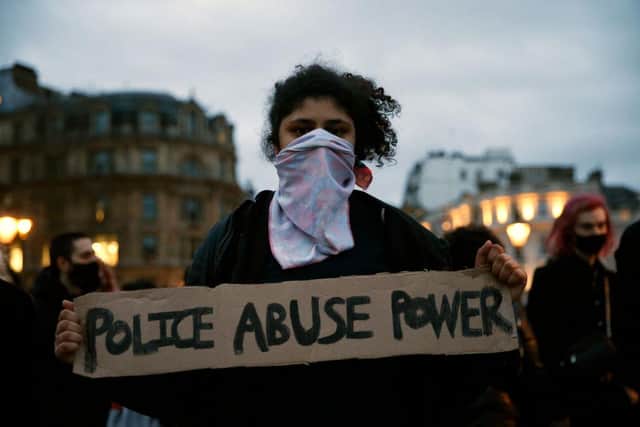 A member of the public holds up a sign reading 'POLICE ABUSE POWER' in Trafalgar Square during a protest against the The Police, Crime, Sentencing and Courts Bill and criticising the actions of the police at the Clapham Common vigil on 14 March (Photo: Hollie Adams/Getty Images)