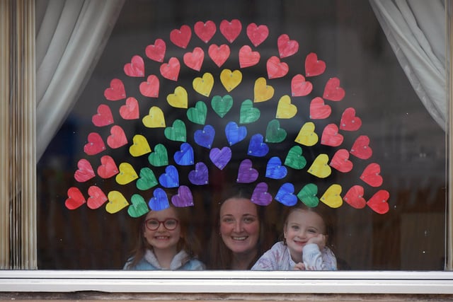 Elise and Rhianne Lightbody with a little help from mum Kirsty painted a rainbow on their window to spread a little joy.