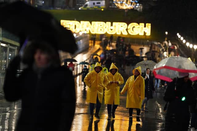 Revellers were hit by downpours as Edinburgh's Hogmanay party got under. Picture: Andrew Milligan/PA Wire