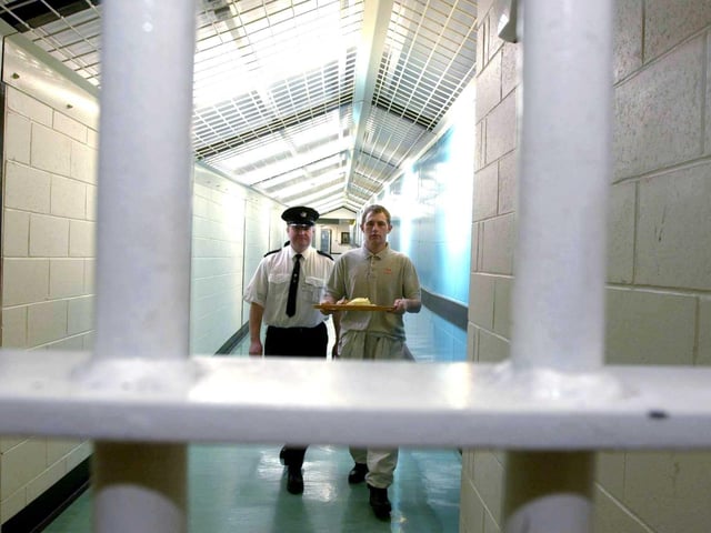 A prisoner carries a tray of food inside Saughton Prison in February, 2000.