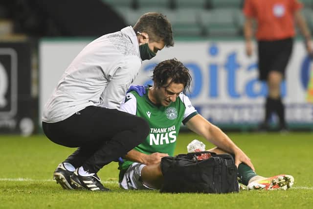 Hibs midfielder Joe Newell receives treatment for his injured shoulder during the match against Hamilton on Friday. Photo by Craig Foy / SNS Group