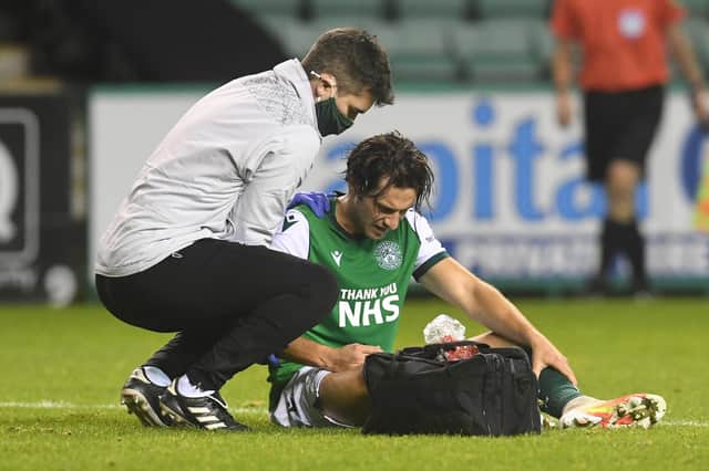 Hibs midfielder Joe Newell receives treatment for his injured shoulder during the match against Hamilton on Friday. Photo by Craig Foy / SNS Group