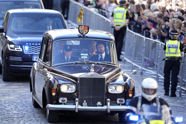King Charles III and the Queen Consort are driven along the Royal Mile ahead of the Procession of Queen Elizabeth's coffin from the Palace of Holyroodhouse to St Giles' Cathedral, Edinburgh. Picture date: Monday September 12, 2022.