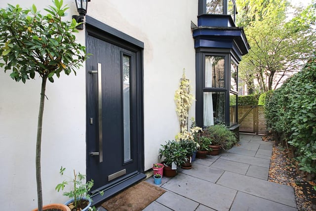 This sleek slate-grey front door leads to the entrance hall.