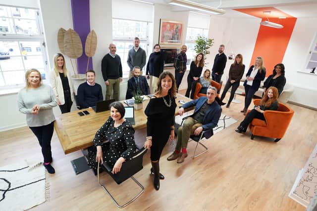 Nicki Denholm (standing at front centre) with the Denholm Associates team at the agency's new hub-style office in Leith. Picture: Stewart Attwood