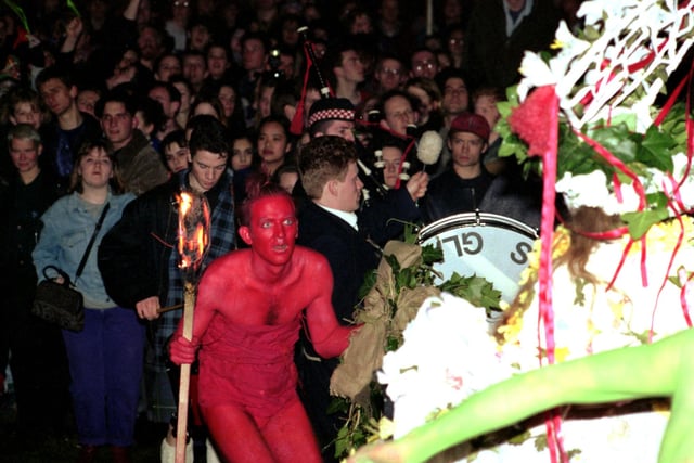 A Red Man, one of the mischievous characters in the Beltane story, attempts to seduce the May Queen.