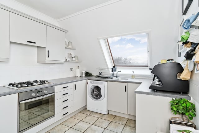 The property's well maintained kitchen.  Extras: an integrated oven and gas hob, a freestanding fridge/freezer, and a washing machine to be included in the sale.
