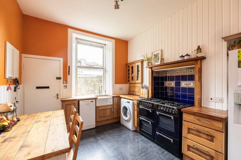 The kitchen is well-fitted and features a dining area, a Belfast sink, and a Stoves range cooker.