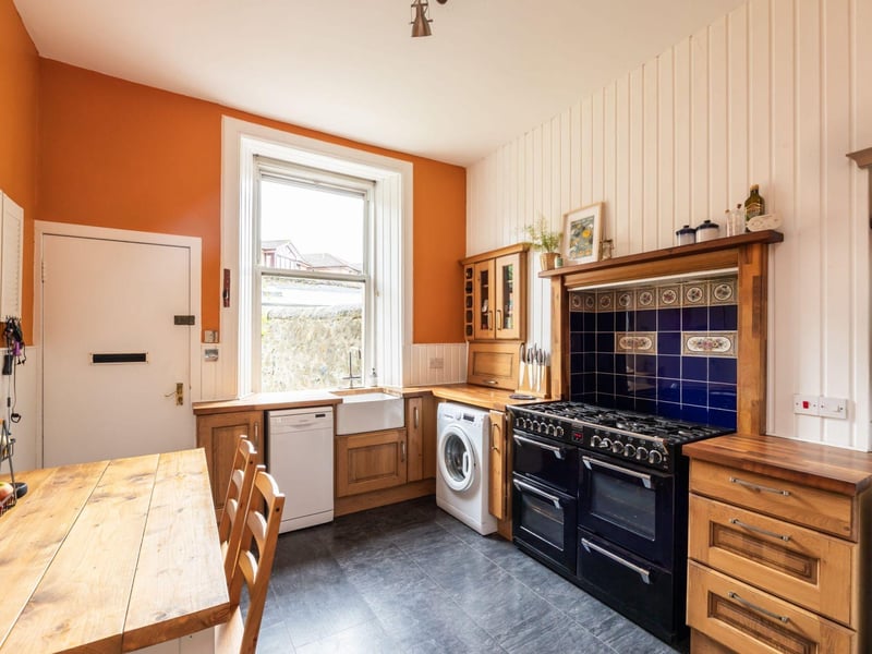The kitchen is well-fitted and features a dining area, a Belfast sink, and a Stoves range cooker.