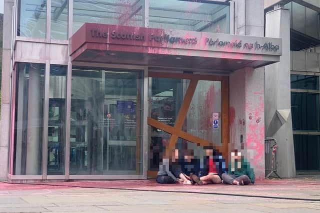Activists hurled paint at the Scottish Parliament building in Edinburgh