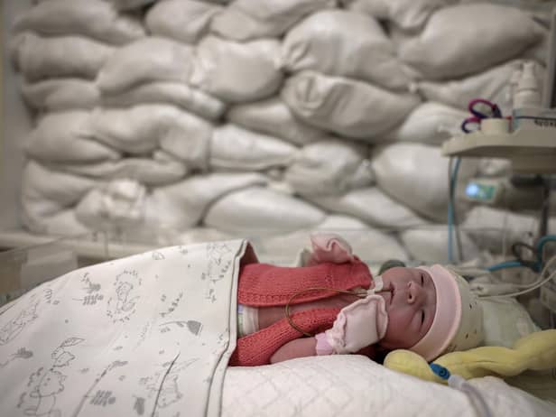 A child rests in a cot beside a window protected by sandbags in an intensive care unit for newborns at Okhmatdyt Hospital, Kyiv, yesterday (Picture: Jeff J Mitchell/Getty Images)
