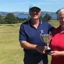 Gullane's Ian Dickson is presented with the R.M. Lees Trophy by Lothians president Jean McNab. Picture: LGA