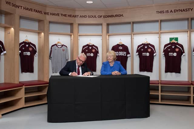 Ann Budge and Stuart Wallace sign documents as Foundation of Hearts become club owners.