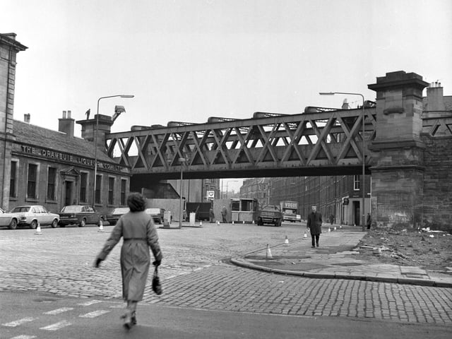The disused railway bridge at Easter Road was dismantled in January 1980. Also in picture, The Drambuie Liqueur Co Ltd sign.