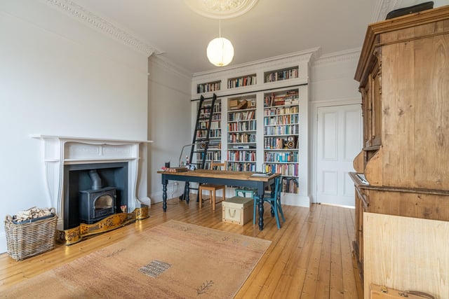 The stunning lounge is a large space with hard wood floors and period accents. The centre piece of the spacious room is the bespoke bookcase which is floor to ceiling and has a sliding ladder.