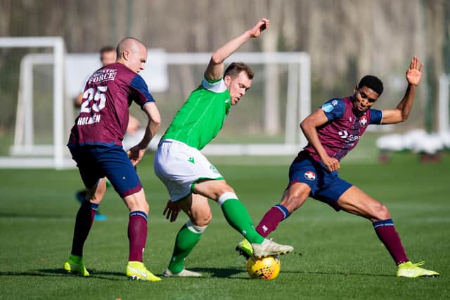 SOTOGRANDE, SPAIN - JANUARY 10: HibernianÕs Steven Whittaker is closed down by Willem IIÕs Driess Saddiki (R) and Sebastian Holmen (L) during a friendly match between Hibernian and Willem II, at Ayala Polo Club, on January 10, 2020, in Sotogrande, Spain. (Photo by Ross Parker / SNS Group)