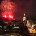 Hogmanay celebrations in Edinburgh with fireworks over the Castle and Balmoral Clock Tower