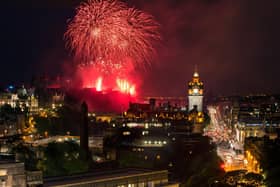 Hogmanay celebrations in Edinburgh with fireworks over the Castle and Balmoral Clock Tower