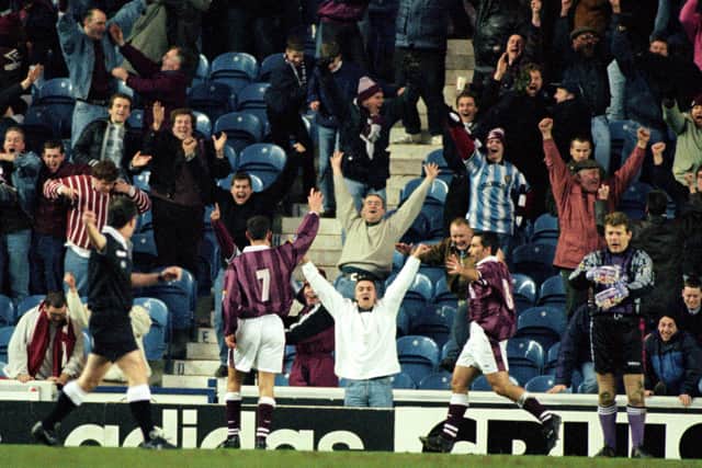 Allan Johnstone (No.7) celebrates in front of the ecstatic Hearts support after scoring one of his three goals in a famous victory over Rangers at Ibrox. Picture: SNS