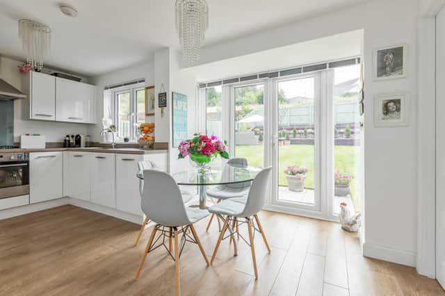 The kitchen/ dining room with french doors leading out to the garden. Photo: Warners.