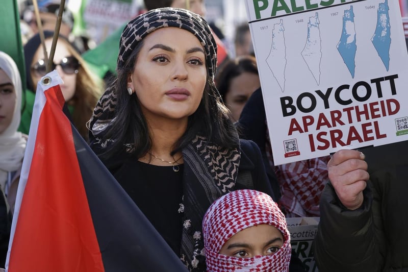 Protesters in Edinburgh, on Armistice day demand ceasefire. They held signs calling to Stop the Genocide and Boycott Apartheid Israel. 
Photo by Jeff J Mitchell/Getty Images)