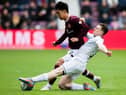 Yutaro Oda picked up a knock in this early challenge from Ross County's George Harmon but recovered to put in an impressive performance. Picture: Mark Scates / SNS