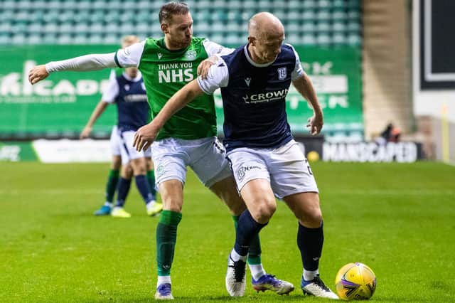 Hibs' Martin Boyle challenges Dundee's Charlie Adam for the ball.