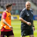 Hearts head coach Frankie McAvoy in discussion with Cammy Devlin during training. Picture: SNS