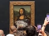 The cake smearing incident was captured by dozens of visitors to the Louvre Museum in Paris
Pic: YouTube