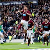 Ryan McGowan roars with delight after scoring his side's fourth goal of the game as Hearts defeated Hibs in the 2012 Scottish Cup final. Picture: SNS