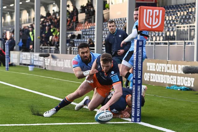 Mark Bennett squeezes into the corner for Edinburgh's third try despite the attentions of Willis Halaholo. (Photo by Paul Devlin / SNS Group)