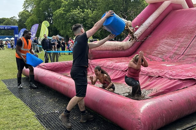 Just when racers thought they'd come to the end of the mud, helpers were on hand to make sure they were well and truly soaked before crossing the finish line.