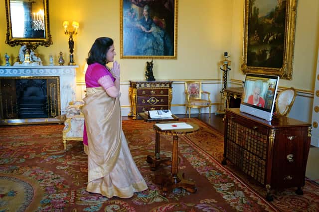 Queen Elizabeth II appears on a screen via videolink from Windsor Castle, where she is in residence, during a virtual audience to receive the High Commissioner of India, Ms. Gaitri Issar Kumar, at Buckingham Palace, London. Picture date: Tuesday March 8, 2022.
