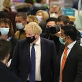 Prime Minister Boris Johnson visits a vaccination centre at a pharmacy in his constituency Uxbridge, London, on Monday. (AP Photo/Frank Augstein)