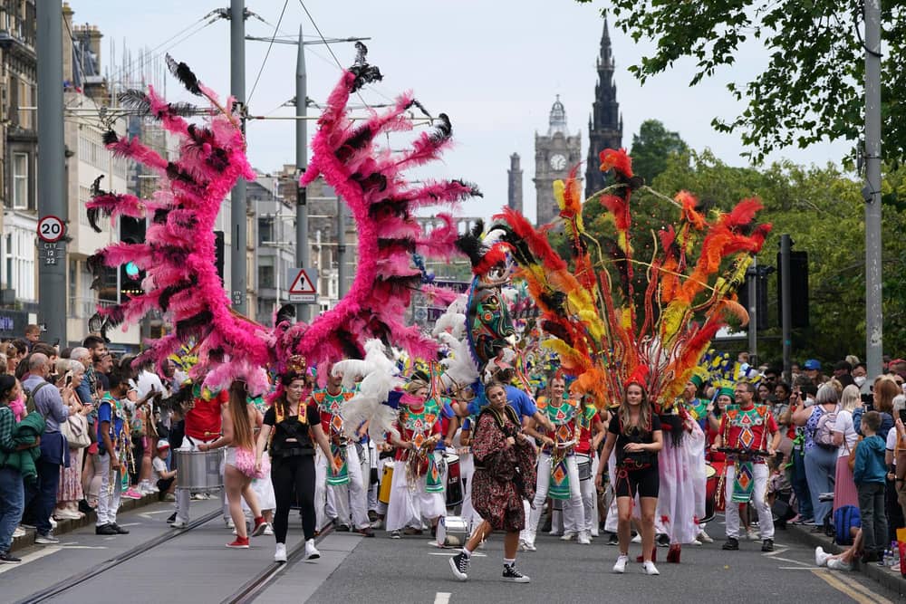Performers from at least 13 countries paraded along Princes Street during the Edinburgh Festival Carnival (Picture: Andrew Milligan/PA)
