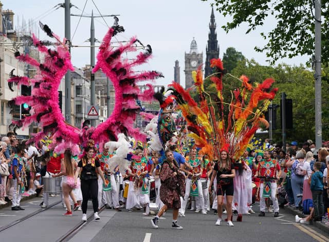 Performers from at least 13 countries paraded along Princes Street during the Edinburgh Festival Carnival (Picture: Andrew Milligan/PA)