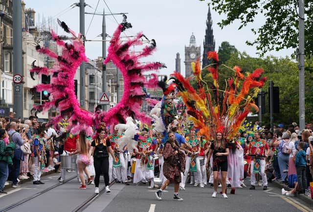 Performers from at least 13 countries paraded along Princes Street during the Edinburgh Festival Carnival (Picture: Andrew Milligan/PA)