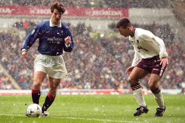 Rangers winger Brian Laudrup is kept in check by Paul Ritchie in February 1998.