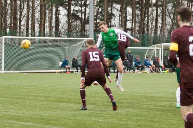 Robbie Hamilton leaps to head home Hibs' second from Oscar MacIntyre's cross. Picture: Maurice Dougan