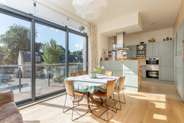 The bright dining/ kitchen area is full of light thanks to the adjoining balcony space. Bringing any rare Scottish sunshine into this impressive property.
