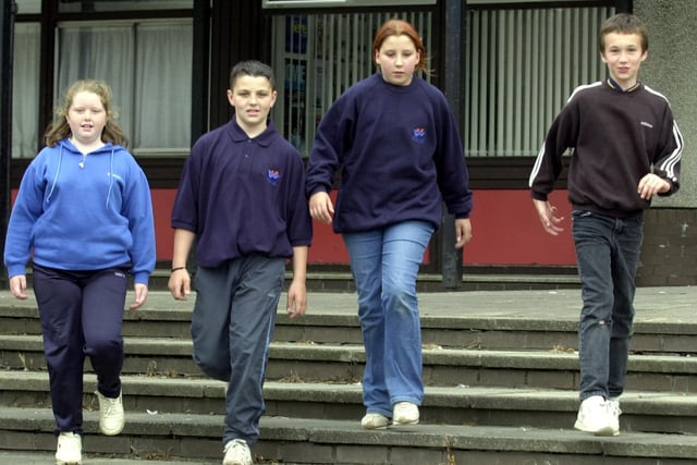 Primary 7 schoolchildren Laura Porteous and Russell Haston (centre) flanked by Kirsty Falkner (left) and Davie Scott with the sweatshirt and polo shirt uniforms of their Wester Hailes secondary that they were all due to join in August 2001.