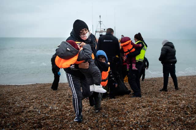 Refugees land on a beach in Dungeness, England (Picture: Ben Stansall/AFP via Getty Images)