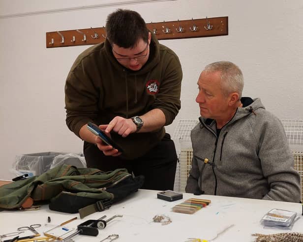 Jason Rennie, chairman of West Lothian Angling Association (left) discusses a point with Scot (cor) Muir at the club's monthly fly tying session. Picture Nigel Duncan
