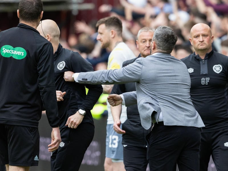 Steven Naismith turns away as Lee Johnson extends his left arm towards the Hearts boss