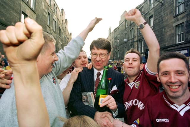 Eric Milligan celebrates with young fans and shares in their bottle of Buckfast