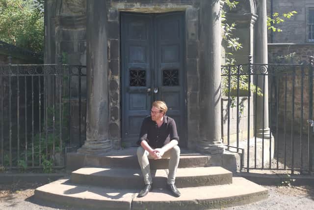 Ryan Latto outside Mackenzie's tomb in Greyfriars Kirkyard